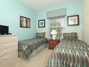 A bedroom with two beds, a dresser, a television, and framed pictures on the wall. - Ov3718 - Windsor Palms Resort - 3 Bed 2 Baths Townhome (Kissimmee)