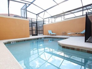 An indoor swimming pool with clear glass walls, a tiled floor, and a few lounge chairs. - Ov3708 - Paradise Palms - 4 Bed 3 Baths Townhome (Kissimmee)