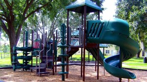 A playground with a slide and climbing structures.