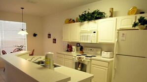 A kitchen with white cabinets, a stove, a refrigerator, and a sink. - Ov3649 - Windsor Hills Resort - 5 Bed 5 Baths Villa (Kissimmee)