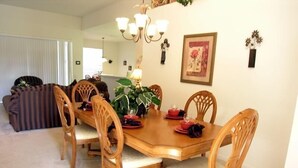A dining room with a wooden table, six chairs, and a chandelier. - Ov3649 - Windsor Hills Resort - 5 Bed 5 Baths Villa (Kissimmee)