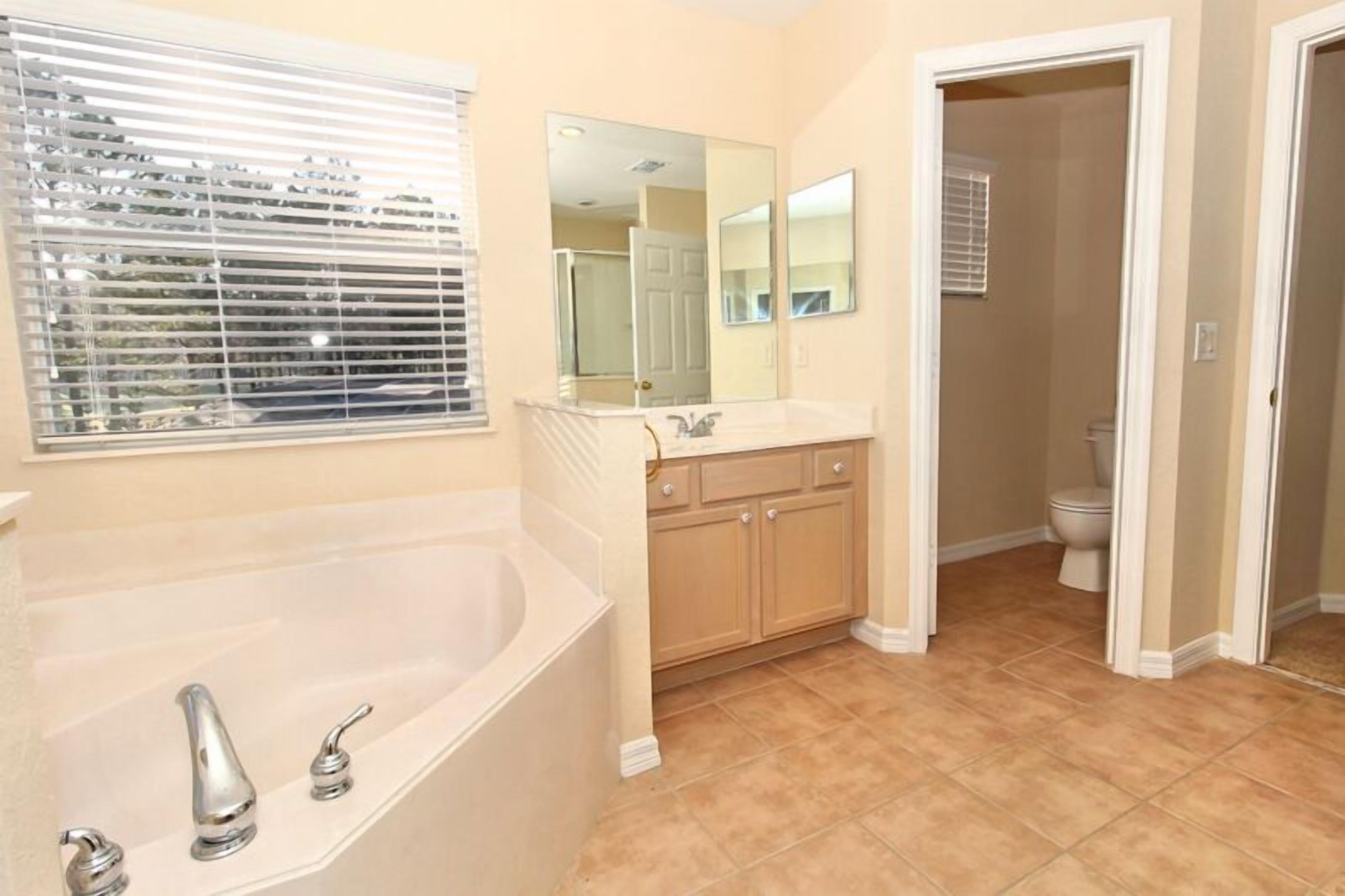 A bathroom with a bathtub, sink, and toilet.