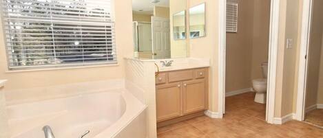 A bathroom with a bathtub, sink, and toilet.