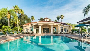 A pool area with lounge chairs and a building with a tiled roof. - Ovm3553 - Emerald Island - 5 Bed 3 Baths Villa (Kissimmee)