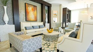 A modern living room with a sofa, armchairs, a coffee table, and a decorative bowl. - Ov3520 - Solterra Resort - 5 Bed 4.5 Baths Villa (Davenport)