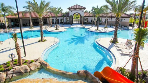 A resort with a large central pool, smaller surrounding pools, palm trees, and a building with a red-tiled roof. - Ov3520 - Solterra Resort - 5 Bed 4.5 Baths Villa (Davenport)
