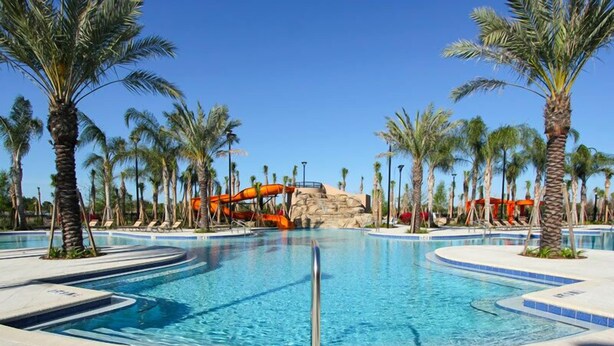 A swimming pool with a water slide, surrounded by palm trees and lounge chairs. - Ov3223 - Solterra Resort - 5 Bed 5 Baths Villa (Davenport)