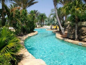 A clear blue pool surrounded by palm trees and rocks, with a sign indicating a depth of 3 feet. - Ov3248 - Reunion Resort - 5 Bed 5 Baths Villa (Kissimmee)