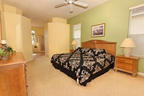 A bedroom with a bed, bedside tables, a ceiling fan, and a framed picture on the wall. - Ov3156 - Highlands Reserve - 4 Bed 3 Baths Villa (Davenport)