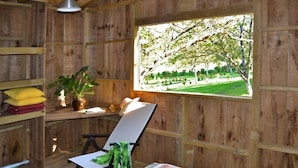 A wooden room with a window, a chair, a table, and a bed. - Moulin des Sandaux Natur'park (Saint-Andre-et-Appelles)