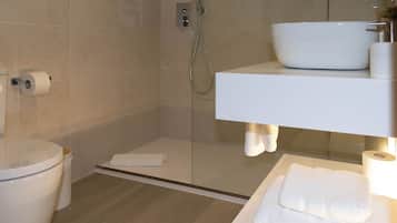 Habitación Deluxe doble | Baño | Ducha, cabezal de ducha tipo lluvia y toallas