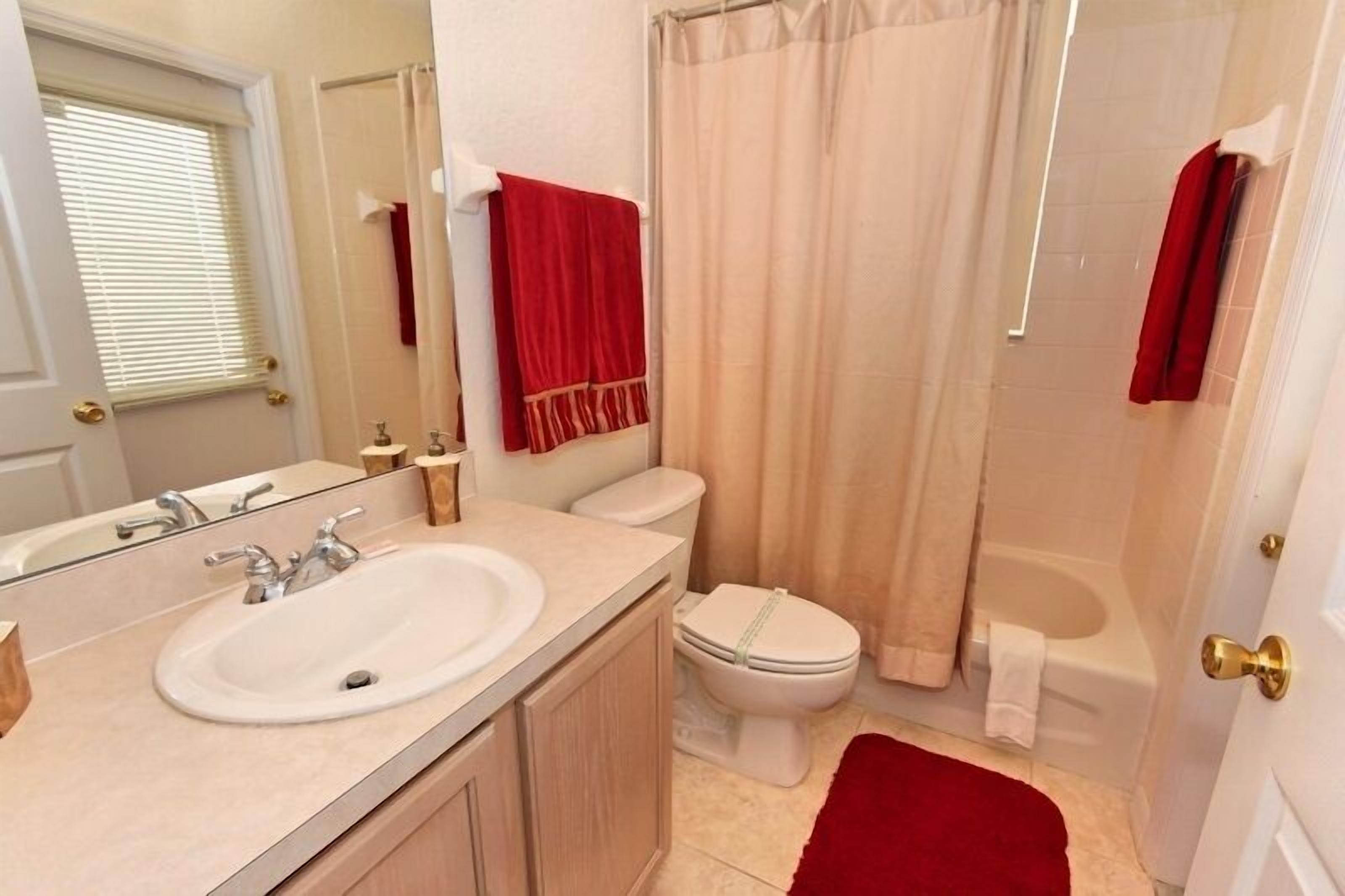 A bathroom with a sink, toilet, and bathtub.