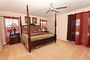 A four-poster bed with a canopy, a ceiling fan, and a nightstand with a lamp. - Ov3113 - The Shire at West Haven - 5 Bed 4 Baths Villa (Davenport)