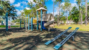 A playground with a slide, climbing structures, and swings. - Ov3102 - Highlands Reserve - 4 Bed 3 Baths Villa (Davenport)