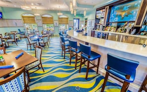 Relax in our stylish lobby, featuring a central bar area, comfortable seating, and beautiful artwork.