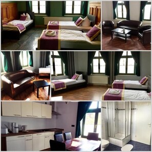 A hotel room with two beds, a sofa, a dining area, and a shower. - Ferienwohnung Alabama (Lutherstadt Wittenberg)