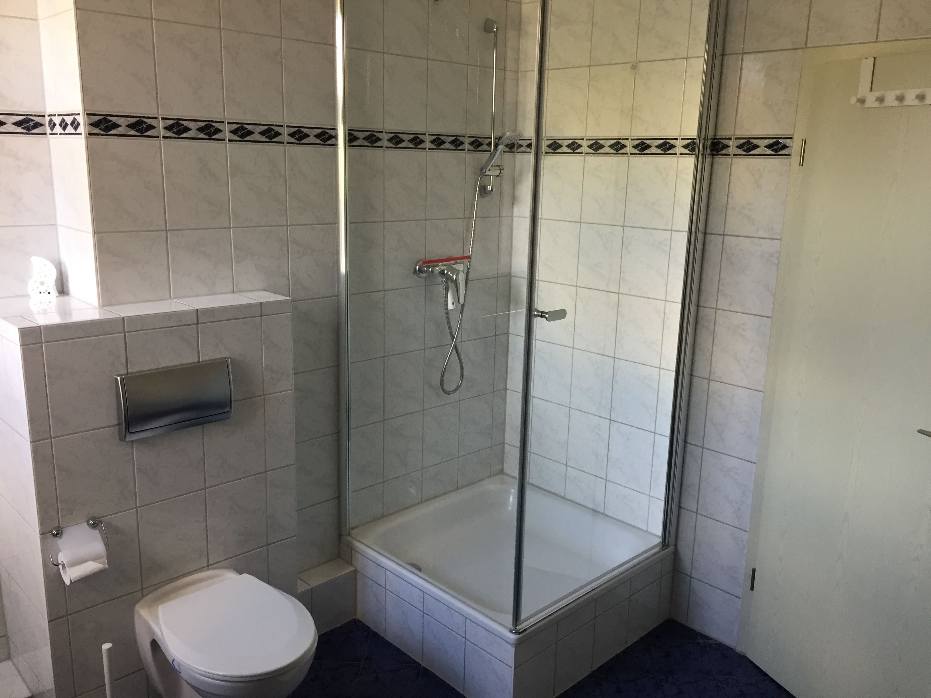 Ein Badezimmer mit Duschkabine, Toilette und Badewanne.