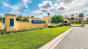 A gated entrance with a sign reading "Paradise Palms Community."