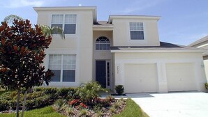 A two-story house with a garage, a front door, and a small porch. - Ov2935 - Windsor Hills Resort - 5 Bed 5 Baths Villa (Kissimmee)