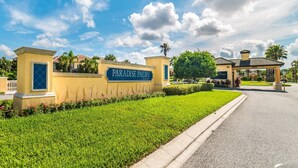 A gated entrance with a sign reading "Paradise Palms Community."