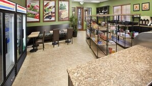 A restaurant with a green wall, a counter with a granite top, and a display of food items. - Ov2888 - Paradise Palms - 5 Bed 4 Baths Villa (Kissimmee)