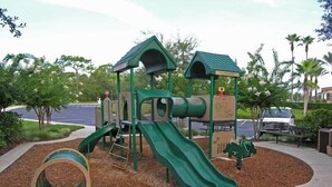 A playground with a slide, climbing structures, and a ball pit. - Ov2644 - Emerald Island - 3 Bed 2.5 Baths Townhome (Kissimmee)