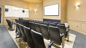 A conference room with rows of chairs, a projector screen, and a whiteboard. - Ov2563 - Windsor Hills Resort - 3 Bed 3 Baths Townhome (Kissimmee)