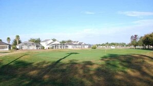 A residential area with houses, a large grassy field, and a clear sky. - Ov2682 - Espirit - 4 Bed 2.5 Baths Villa (Davenport)