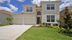 A two-story residential house with a tiled roof, a front garage, and a well-maintained lawn. - Ov2658 - Windsor Hills Resort - 5 Bed 5 Baths Villa (Kissimmee)