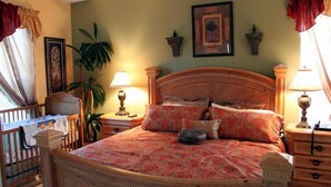 A bedroom with a wooden bed, two bedside tables, a nightstand, a desk, and a chair. - Ov2182 - Emerald Island - 7 Bed 5.5 Baths Villa (Kissimmee)