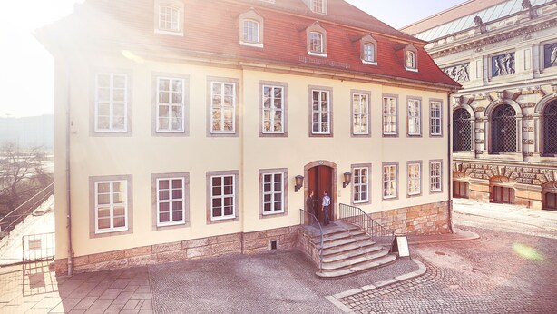 A historic building with a symmetrical facade, multiple windows, and a central entrance with steps. - Hofgärtnerhaus (Dresden)