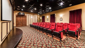 A theater with rows of red seats, a stage, and a patterned carpet. - Ov2668 - Paradise Palms - 6 Bed 5 Baths Villa (Kissimmee)