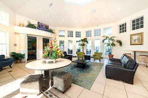 Relax in a welcoming space with a central table, comfortable seating, and a large window offering a view.