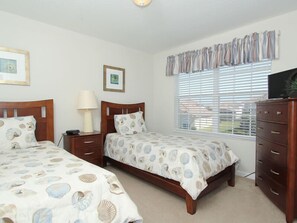 A bedroom with two beds, a dresser, a lamp, and a window with blinds. - Ov2542 - Windsor Hills Resort - 6 Bed 4 Baths Villa (Kissimmee)