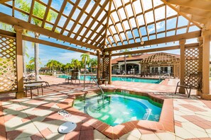 A covered pool area with a hot tub, lounge chairs, and a pool table. - Ov2465 - Bella Vida Resort - 6 Bed 5.5 Baths Villa (Kissimmee)