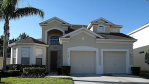 A two-story house with a garage, a small attached garage, and a front entrance. - Ov2484 - Windsor Hills Resort - 5 Bed 5 Baths Villa (Kissimmee)