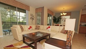 A modern living room with a sectional sofa, a coffee table, and a patterned rug. - Ov2884 - Paradise Palms - 6 Bed 5 Baths Villa (Kissimmee)