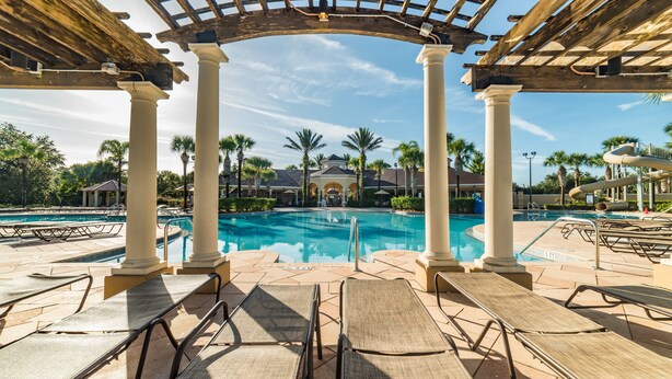 A pool area with lounge chairs, palm trees, and a pergola structure. - Ov2545 - Windsor Hills Resort - 5 Bed 5 Baths Villa (Kissimmee)