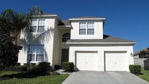 A two-story house with a garage, a covered front porch, and a well-maintained lawn. - Ov2545 - Windsor Hills Resort - 5 Bed 5 Baths Villa (Kissimmee)