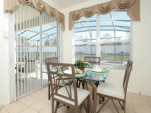Enjoy meals in this dining area with a glass table and comfortable seating.