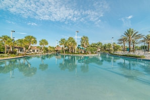 A clear swimming pool surrounded by palm trees and lounge chairs, with a clear sky above. - Ov2858 - Champions Gate Resort - 9 Bed 5 Baths Villa (Davenport)