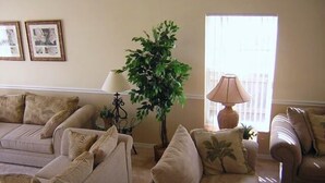 A living room with two sofas, a potted plant, and a lamp. - Ov2186 - Lindfields - 5 Bed 3 Baths Villa (Kissimmee)