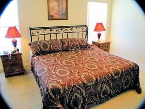 A bedroom with a bed, two nightstands, a lamp on each nightstand, and a painting on the wall. - Ov2186 - Lindfields - 5 Bed 3 Baths Villa (Kissimmee)