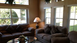 A living room with two sofas, a glass coffee table, and a lamp. - Ov1484 - Emerald Island - 4 Bed 3.5 Baths Townhome (Kissimmee)