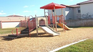 A playground with a red slide and a climbing structure. - Ov2749 - High Grove - 4 Bed 3 Baths Villa (Clermont)