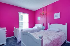 A bedroom with two white beds, a chandelier, a globe on a bedside table, and a window with blinds. - Ovm1307 - Emerald Island - 3 Bed 2.5 Baths Townhome (Kissimmee)