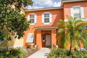 A two-story building with a red facade, white shutters, and a number '2773' above the entrance. - Ovm1307 - Emerald Island - 3 Bed 2.5 Baths Townhome (Kissimmee)