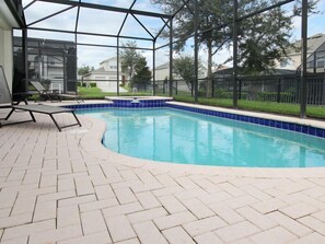 A swimming pool with a tiled edge, surrounded by a brick patio and a covered area with chairs. - Ov2611 - Windsor Hills Resort - 5 Bed 5 Baths Villa (Kissimmee)