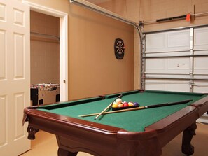 Enjoy a game of pool or try your hand at darts in this spacious room.