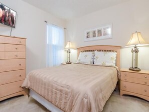 A bedroom with a bed, two bedside tables, a dresser, a window with curtains, and a wall-mounted picture. - Ov535 - Emerald Island - 7 Bed 4 Baths Villa (Kissimmee)
